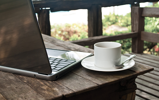 Laptop and mug outside